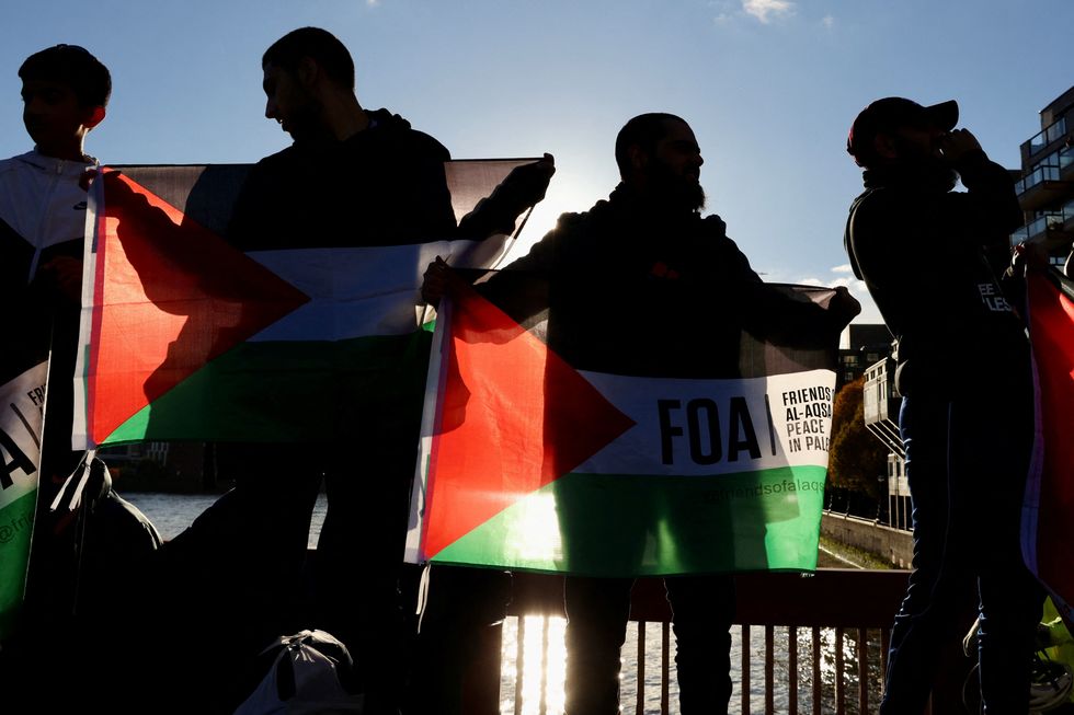 People protest on Vauxhall Bridge during a march in solidarity with Palestinians in Gaza