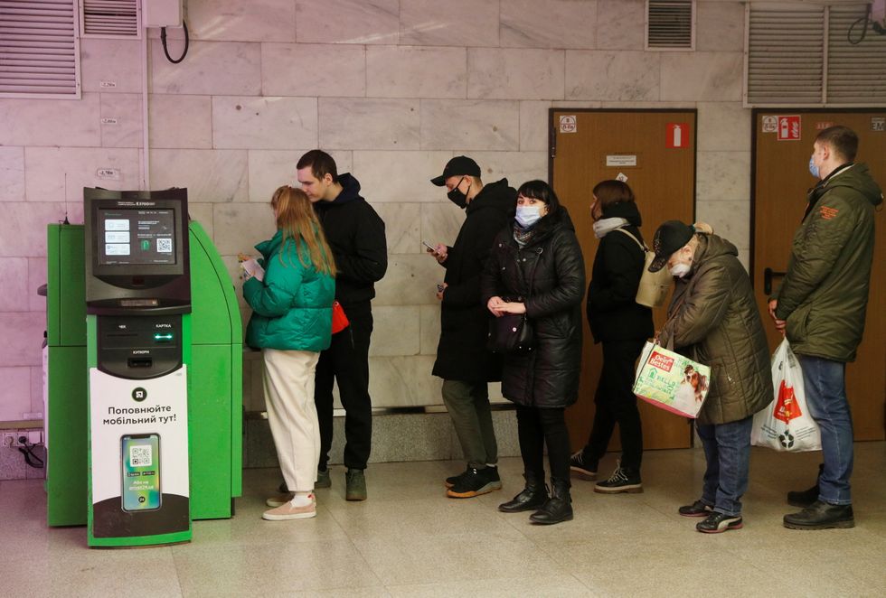 People queue at an ATM after Russian President Vladimir Putin authorised a military operation in eastern Ukraine, in Kyiv, Ukraine February 24, 2022. REUTERS/Valentyn Ogirenko