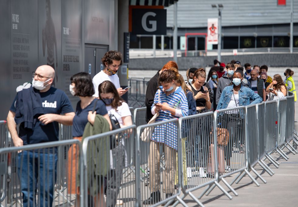 People queue for a mass coronavirus vaccination centre at Arsenal's Emirates Stadium.