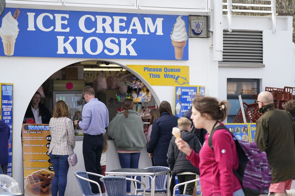People queue for ice creams at Bridlington Beach in Yorkshire.