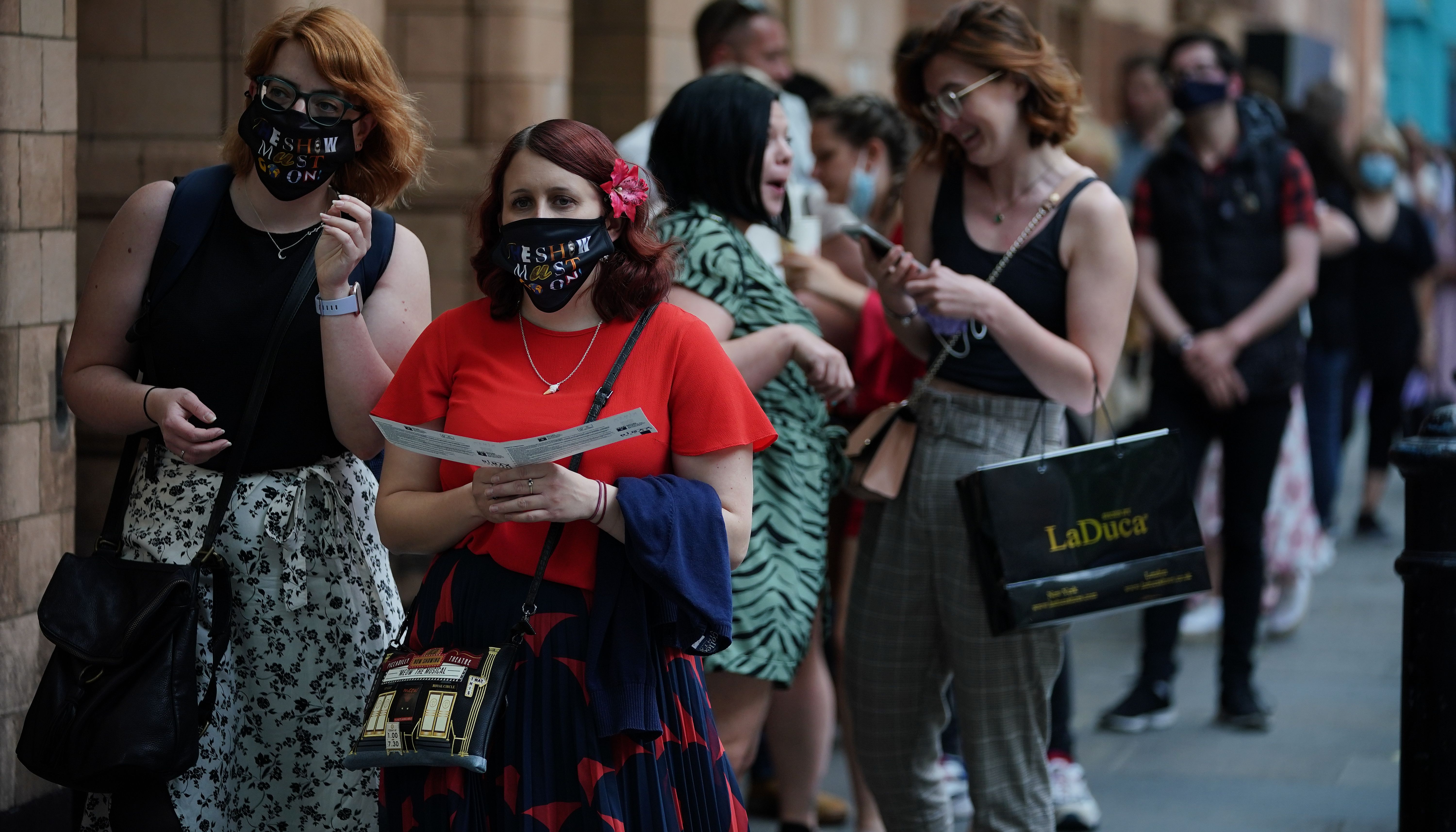 People queue for The Show Must Go On Live at the Palace Theatre in London.