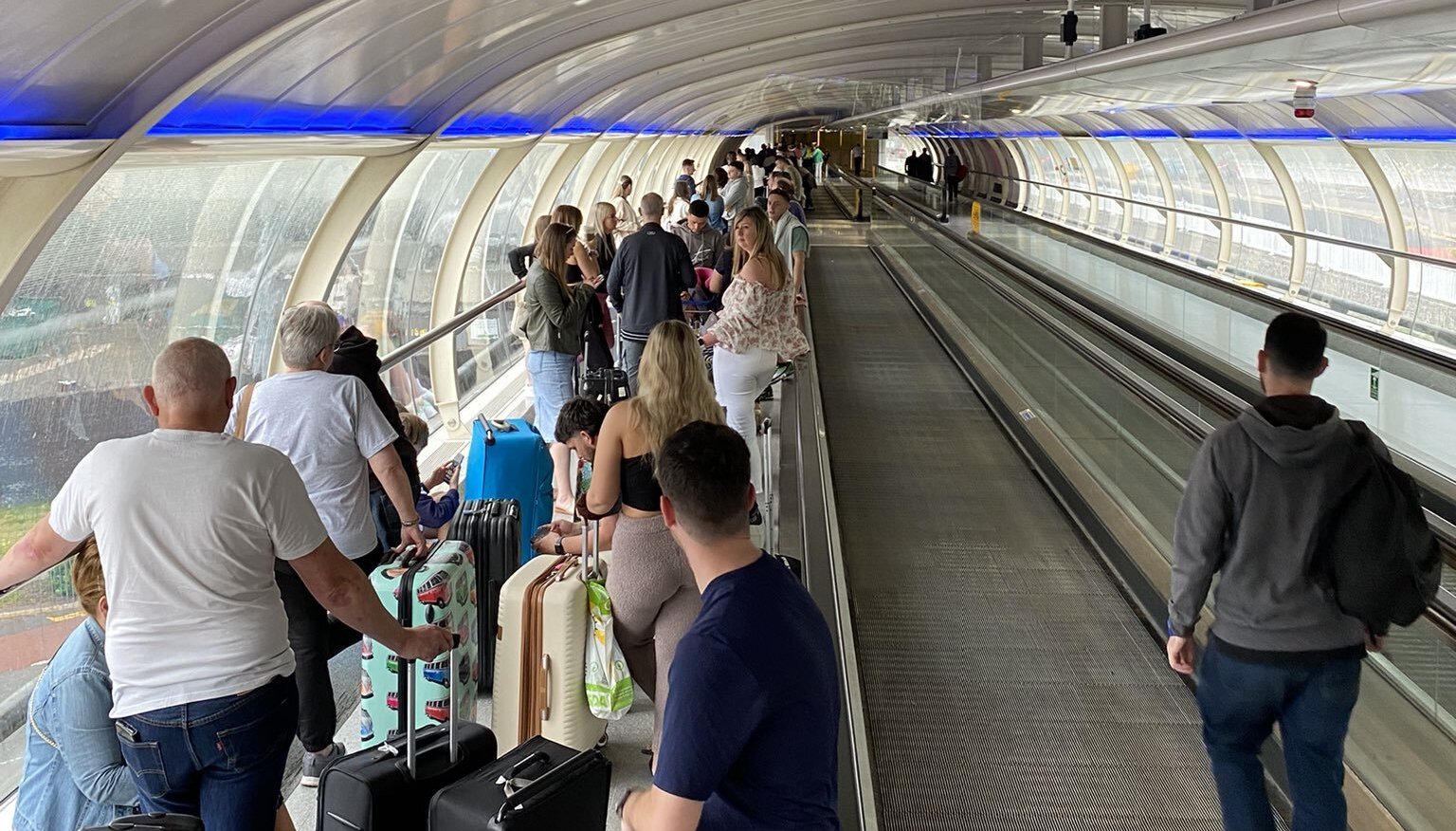 People queuing at Manchester Airport, as Tui has announced a %22small number%22 of flight cancellations.