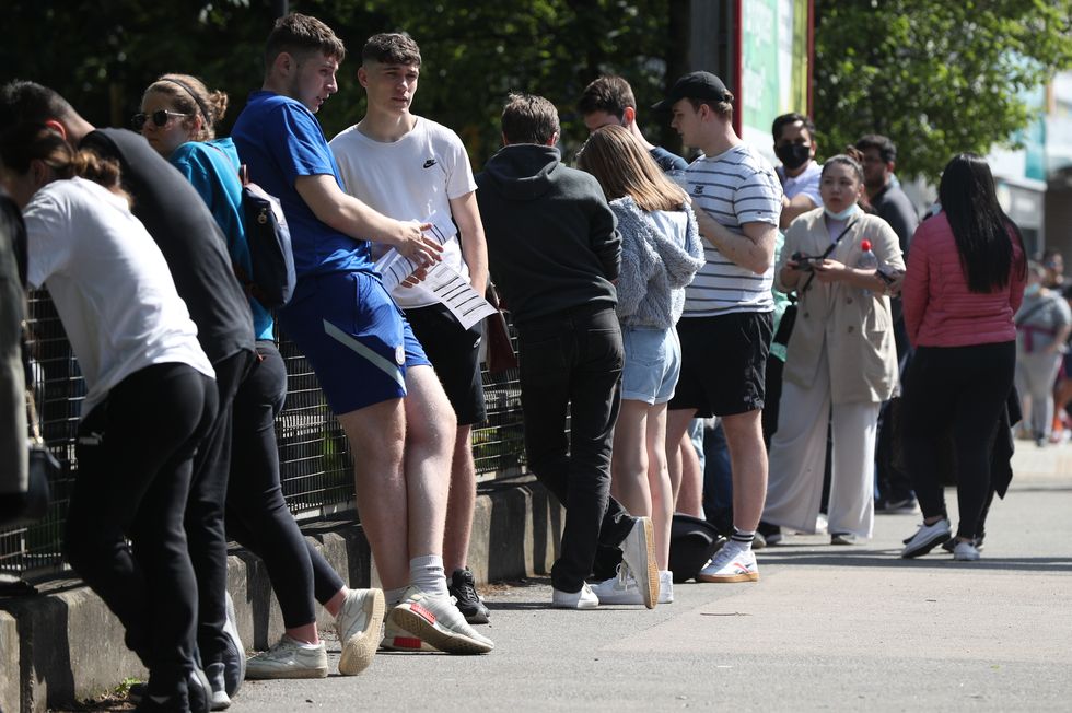 People queuing to go into Belmont Health Centre in Harrow which is offering a first dose of Pfizer coronavirus vaccine to anyone aged over 18 on Saturday and Sunday who is living or working in Harrow. Picture date: Saturday June 5, 2021.