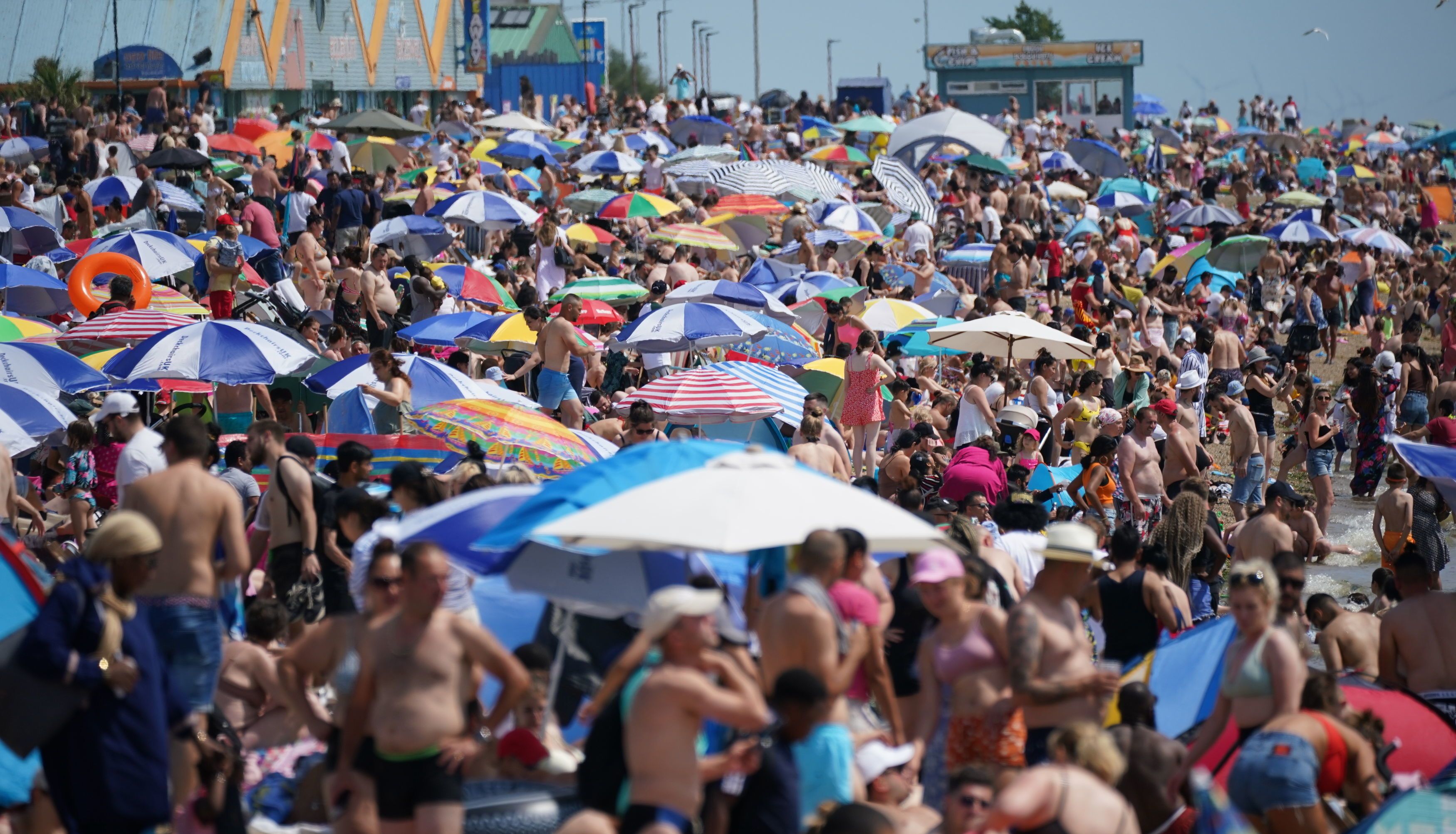 People relax on the beach at Southend-on-Sea on the Thames Estuary in Essex. Temperatures are predicted to hit 31C across central England on Sunday ahead of record-breaking highs next week. Picture date: Sunday July 17, 2022.