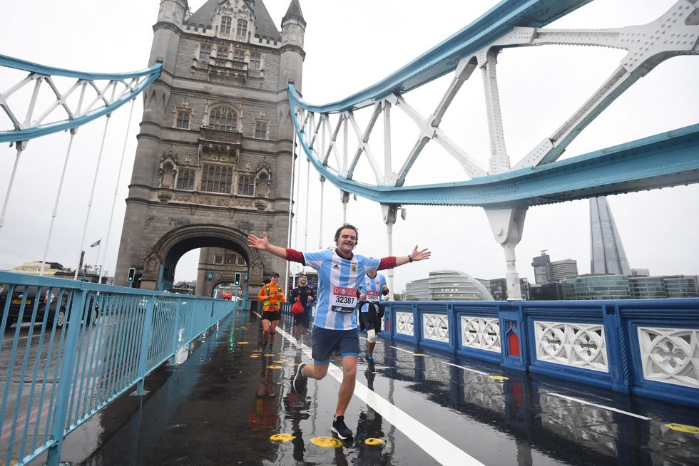 People run across the Tower of London during the 40th London Marathon
