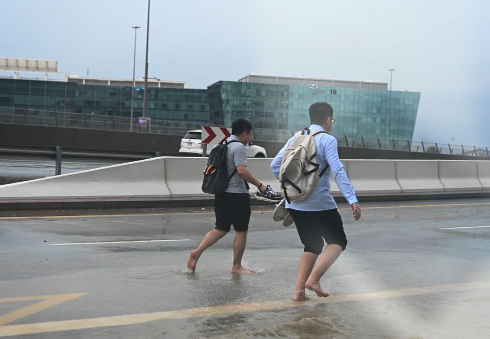 People running through the floods in Dubai