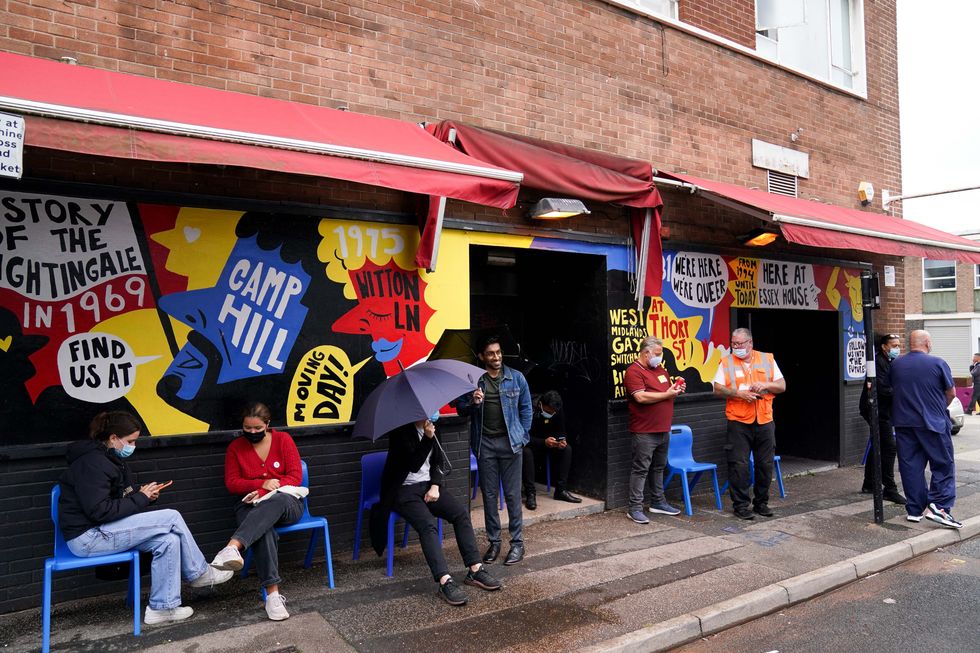 People sit after receiving coronavirus vaccinations at the UK's first nightclub vaccine centre which has been set up at Birmingham's oldest and largest LGBT venue, the Nightingale Club. Picture date: Saturday August 7, 2021.