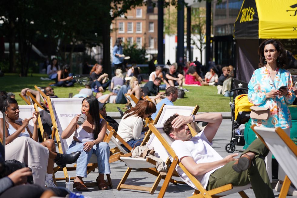 People sitting on chairs in the sun