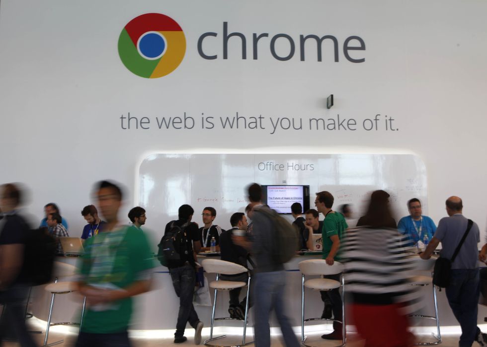 people standing at a chrome branded stand at the google io developer conference