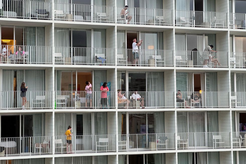 People standing on balconies watching the Beach