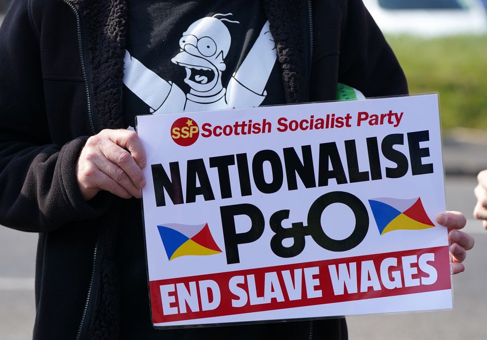 People take part in a demonstration against the dismissal of P&O workers organised by the Rail, Maritime and Transport (RMT) union at the P&O ferry terminal in Cairnryan, Dumfries and Galloway, after the ferry giant handed 800 seafarers immediate severance notices last week.