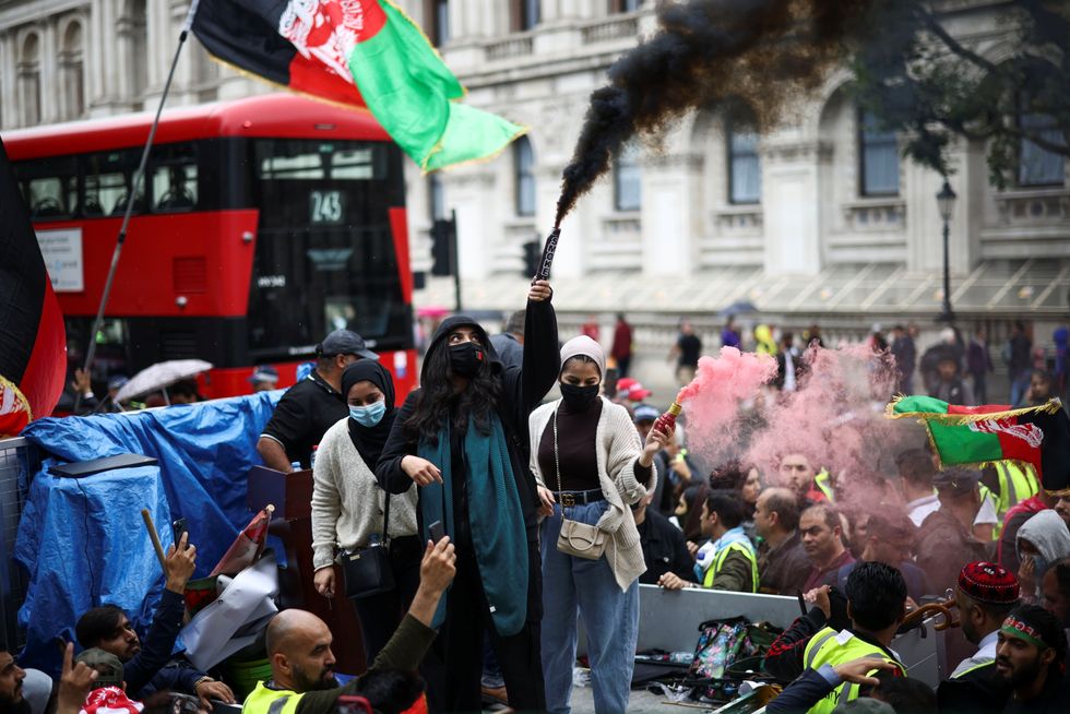 People take part in a demonstration in solidarity with people of Afghanistan, in London.