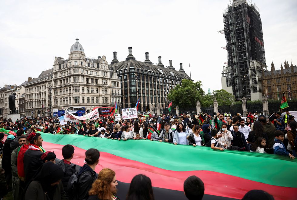 People take part in a demonstration in solidarity with people of Afghanistan, in London.