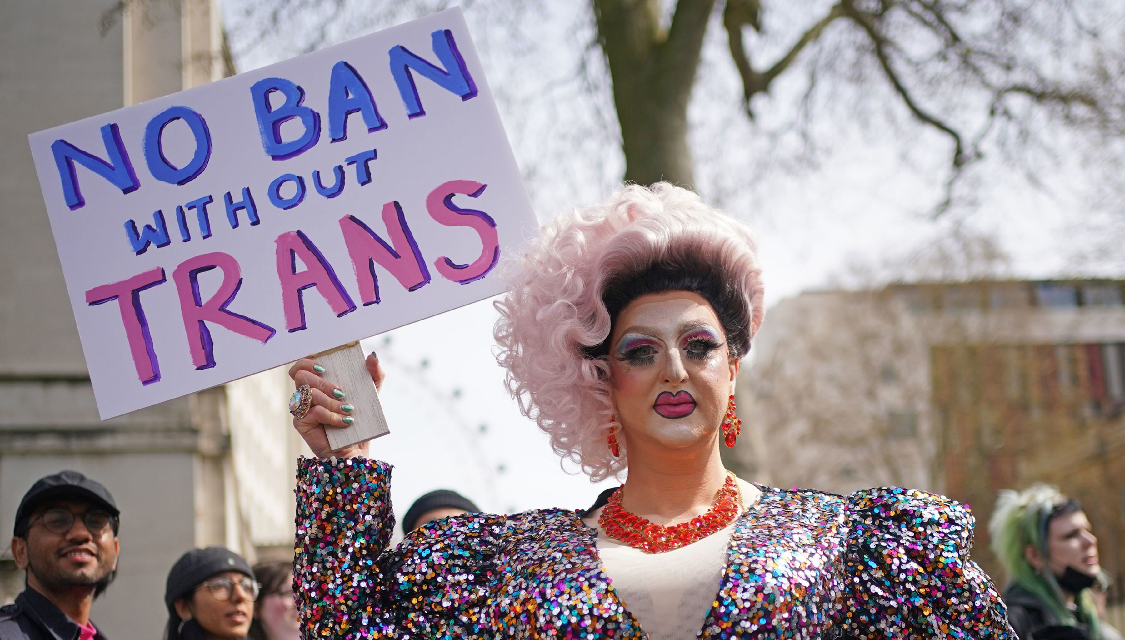 People take part in a protest outside Downing Street in London, over transgender people not being included in plans to ban conversion therapy
