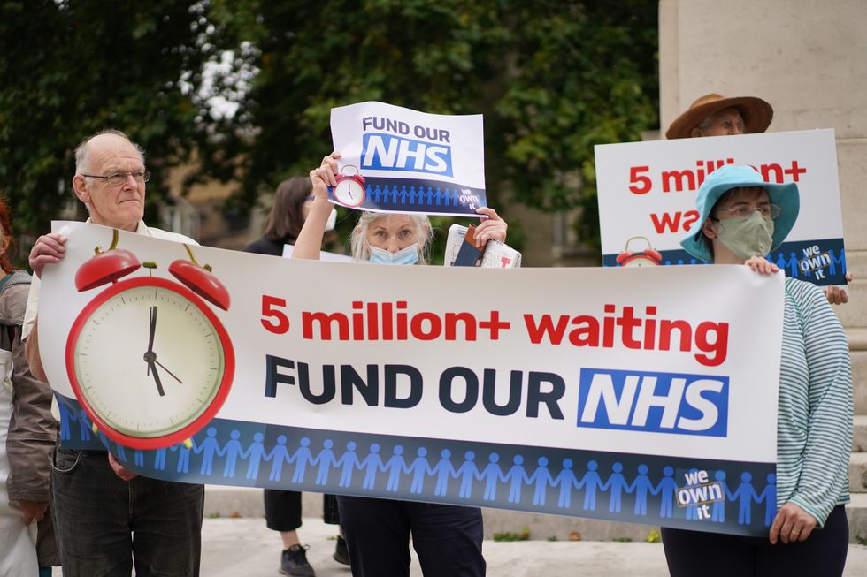 People take part in a protest outside Parliament