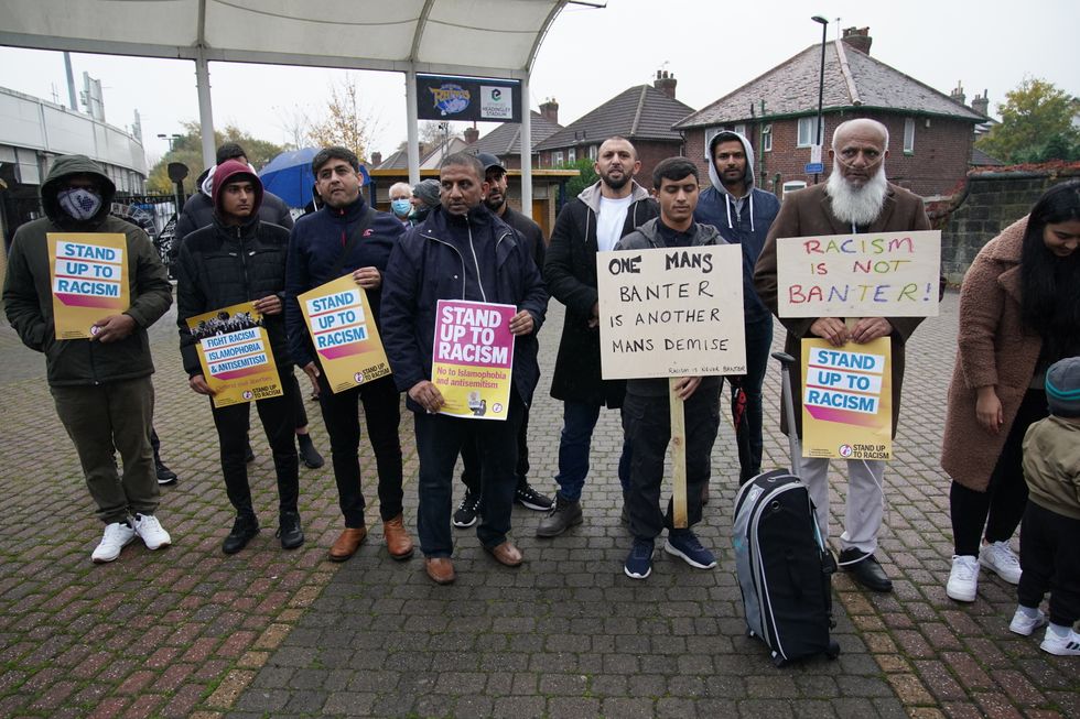 People take part in a protest outside Yorkshire County Cricket Club's Headingley Stadium in Leeds