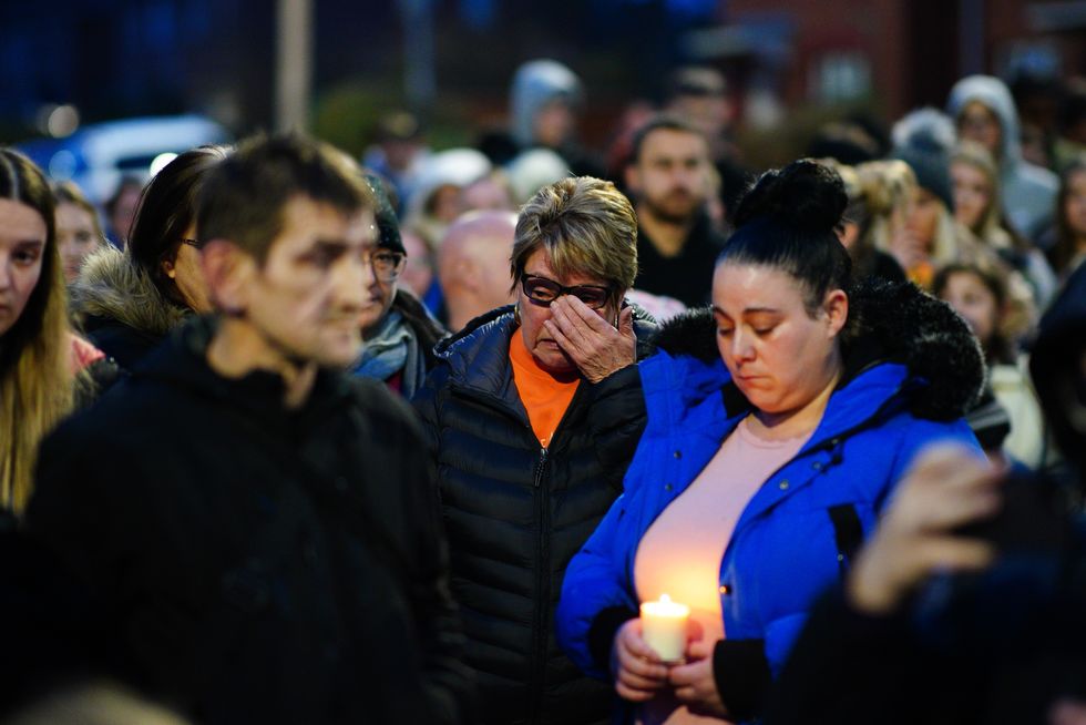 People take part in a vigil near to the scene in south Bristol
