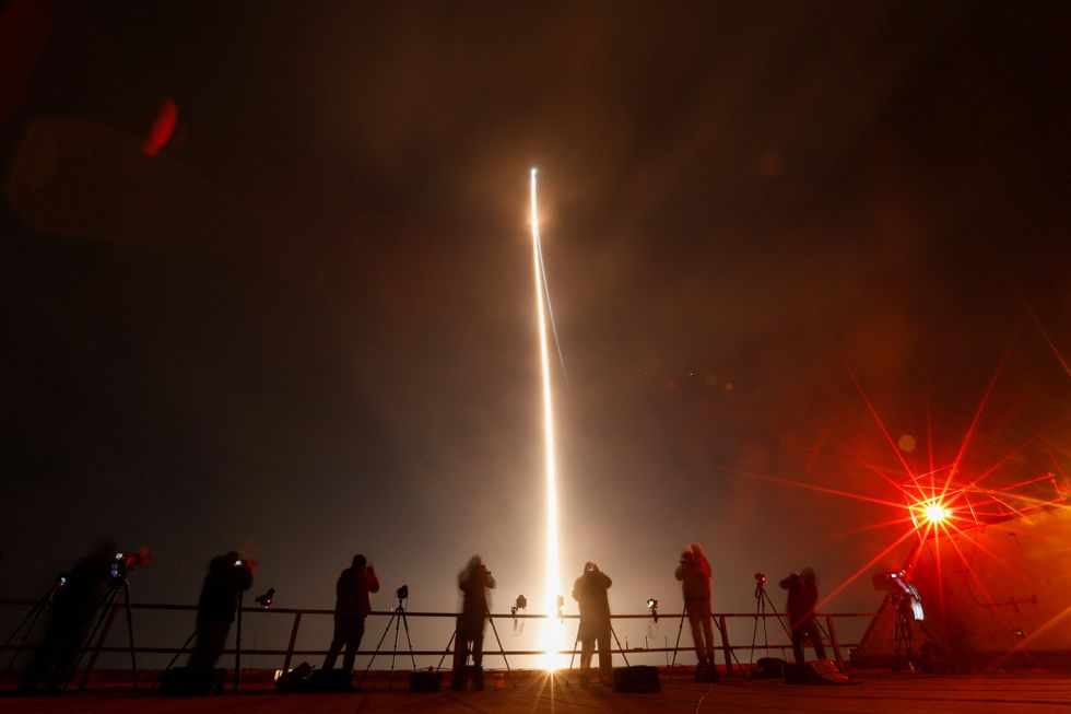 People take photographs during the launch of Boeing-Lockheed joint venture United Launch Alliance's next-generation Vulcan rocket on its debut flight from Cape Canaveral, Florida, U.S.