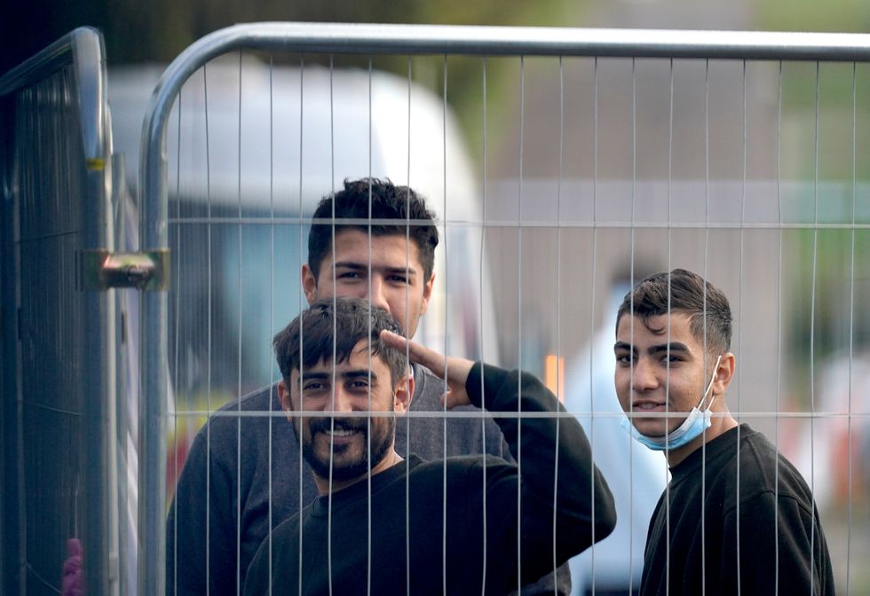 People thought to be migrants inside the Manston immigration short-term holding facility located at the former Defence Fire Training and Development Centre in Thanet, Kent. Picture date: Tuesday November 1, 2022.