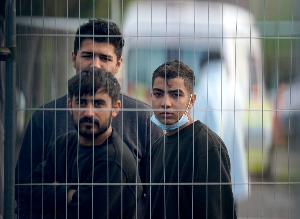 People thought to be migrants inside the Manston immigration short-term holding facility located at the former Defence Fire Training and Development Centre in Thanet, Kent.