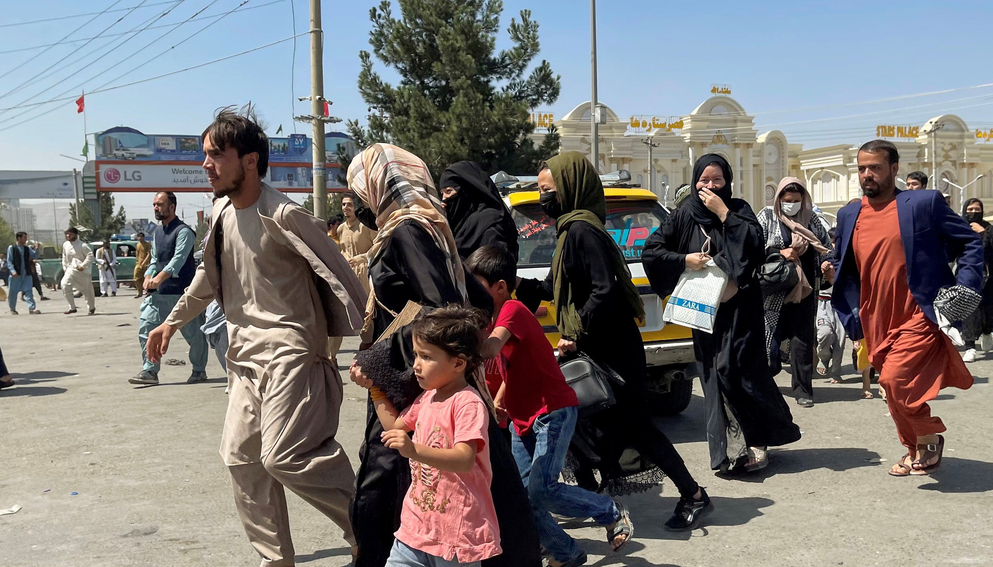 People try to get into Hamid Karzai International Airport in Kabul, Afghanistan August 16, 2021.