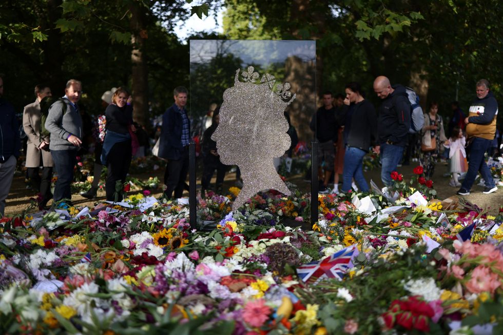 People view floral tributes in Green Park following the death of Britain's Queen Elizabeth, in London, Britain September 18, 2022. REUTERS/Tom Nicholson