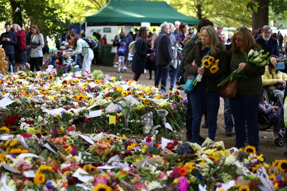 People view floral tributes in Green Park following the death of Britain's Queen Elizabeth, in London, Britain September 18, 2022. REUTERS/Tom Nicholson