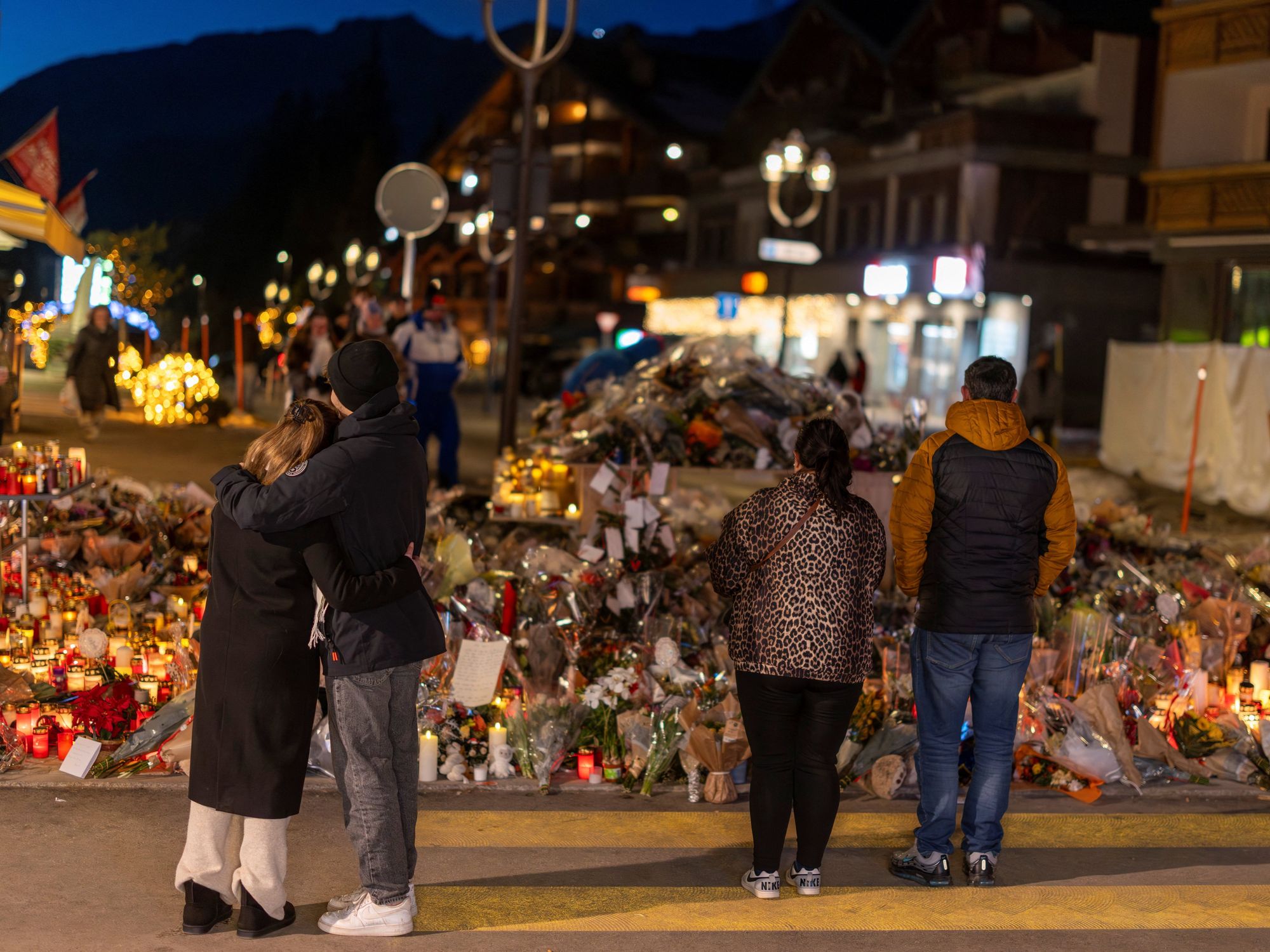 People visit a makeshift memorial outside the "Le Constellation" bar,