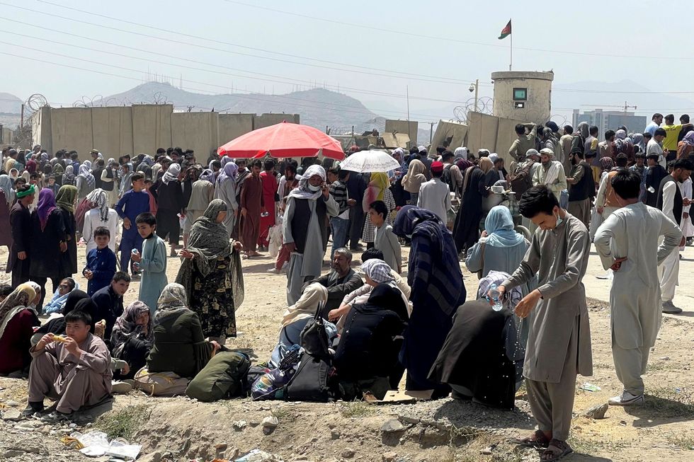 People wait outside Hamid Karzai International Airport in Kabul, Afghanistan August 17, 2021.