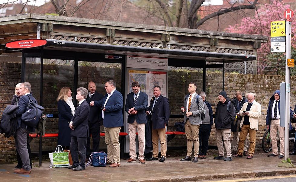 People waiting at a bus stop in England