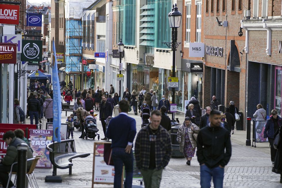 People walk along Peascod Street in Windsor, Berkshire. Concern for the health of The Queen - who is in residence at Windsor Castle - has mounted after she was in direct contact with the Prince of Wales, who has tested positive for Covid. Picture date: Friday February 11, 2022.