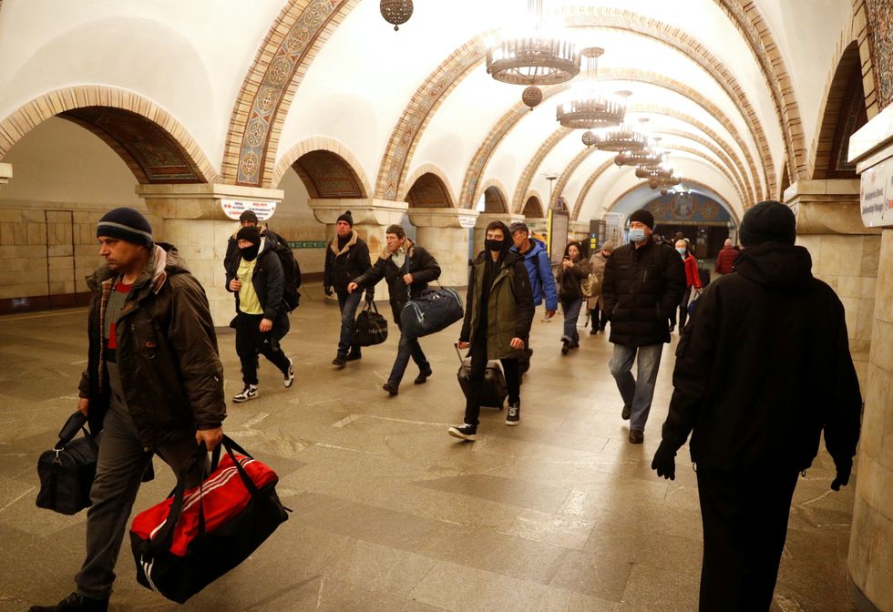 People walk in a subway station, after Russian President Vladimir Putin authorised a military operation in eastern Ukraine, in Kyiv, Ukraine February 24, 2022. REUTERS/Valentyn Ogirenko