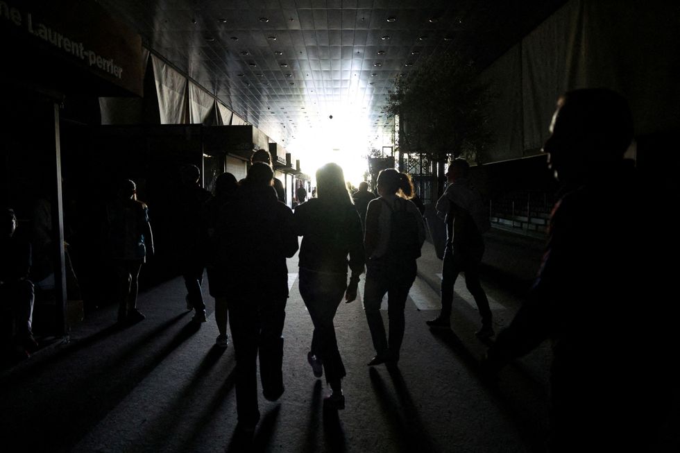 People walk in Park Manzanares as Madrid Open matches were suspended due to a power outag