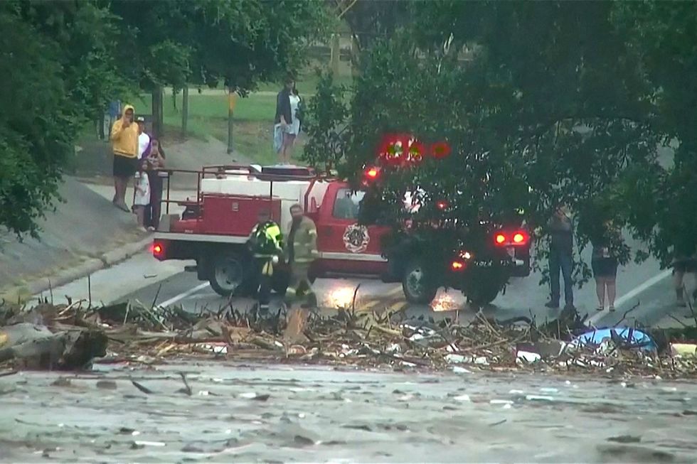 People watch as the flash flood sweeps through
