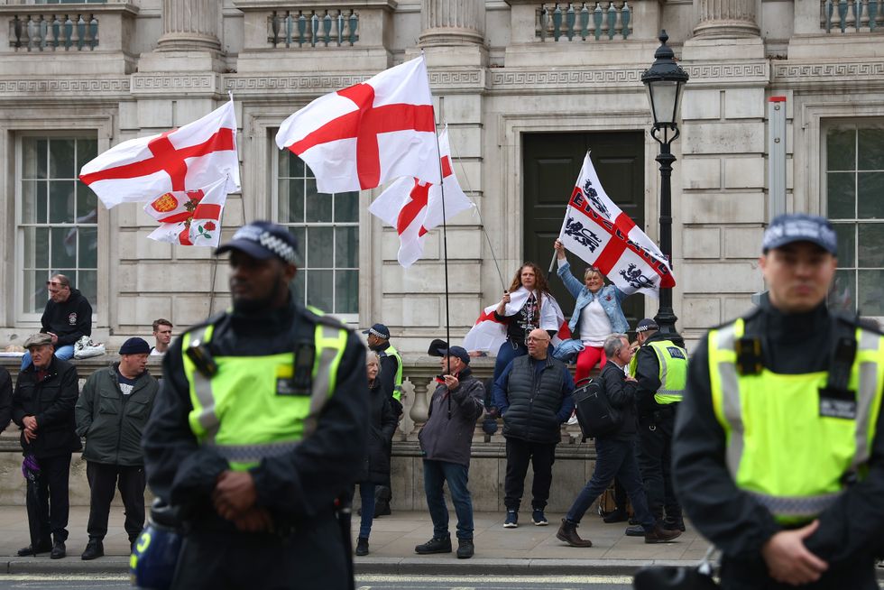 People wave the St George's flag as they attend a demonstration at Richmond Terrace