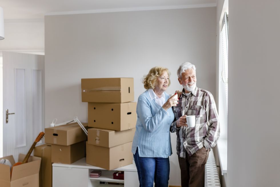 People with boxes having bought house