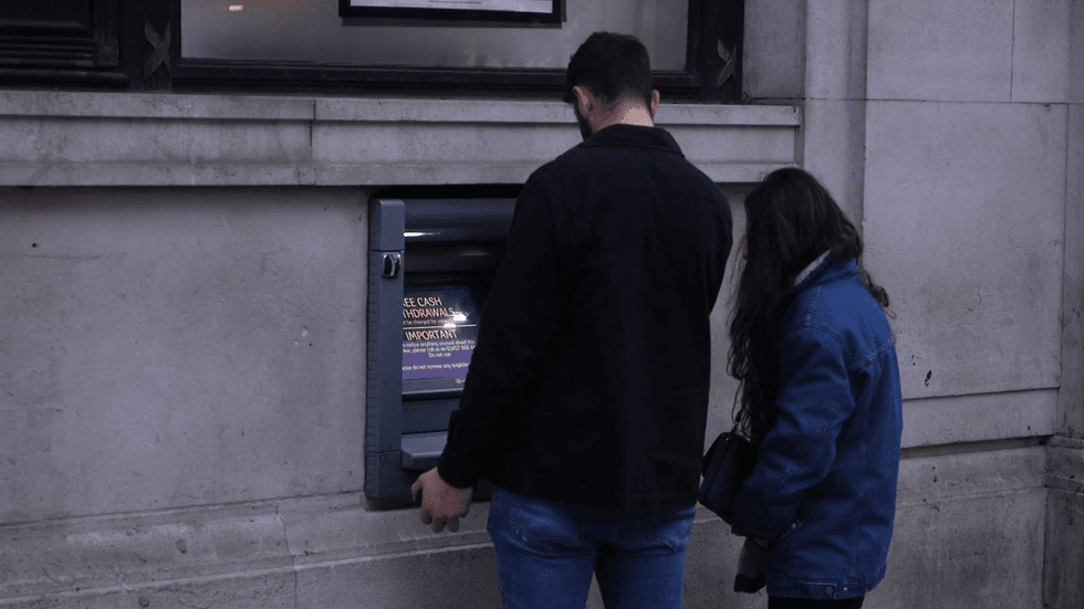 People withdrawing money from an ATM