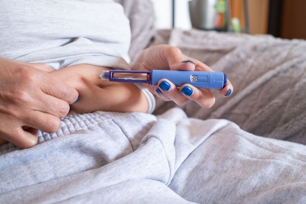 PERSON ADMINISTERING WEIGHT LOSS JAB