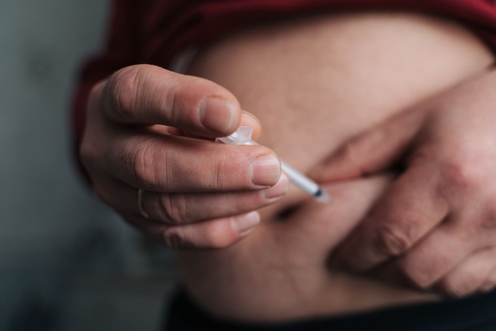 PERSON ADMINISTERING WEIGHT LOSS VACCINE