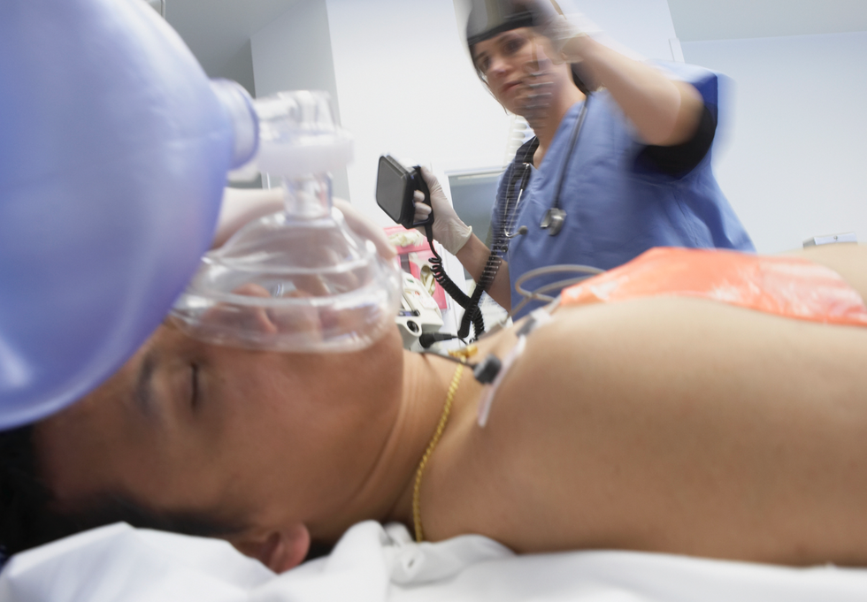 Person being given oxygen in a hospital bed