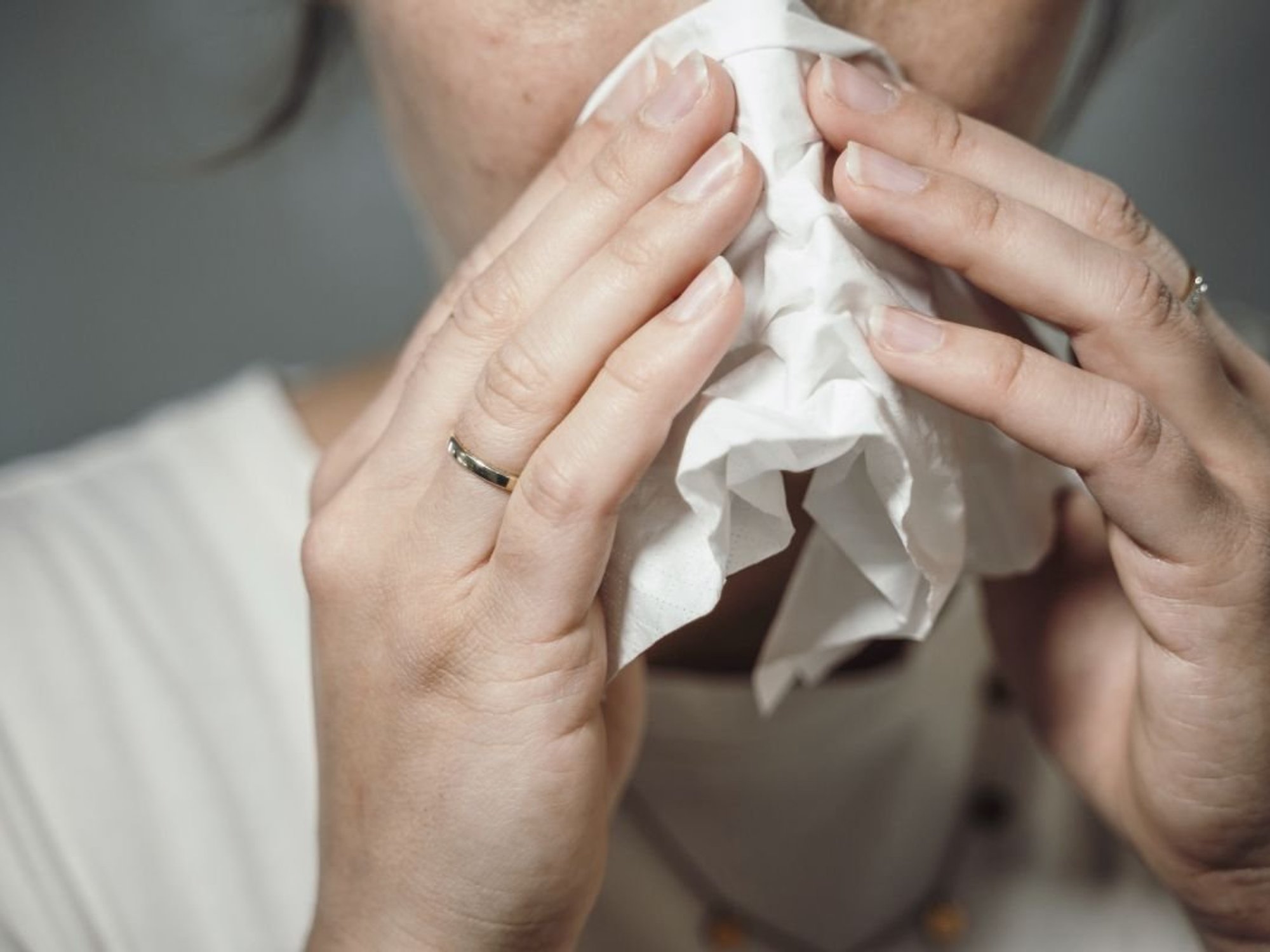 PERSON BLOWING NOSE