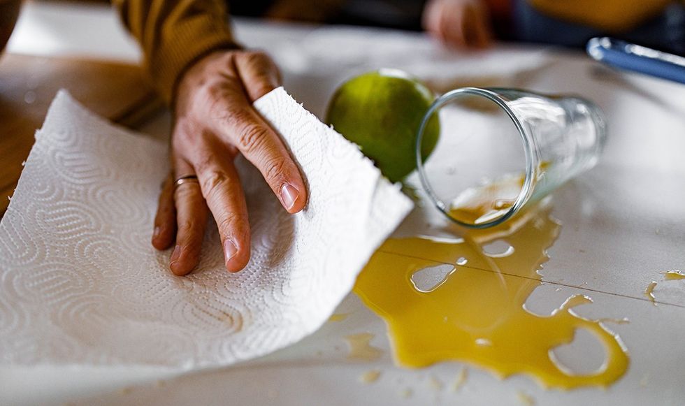 Person cleaning up spilt drink