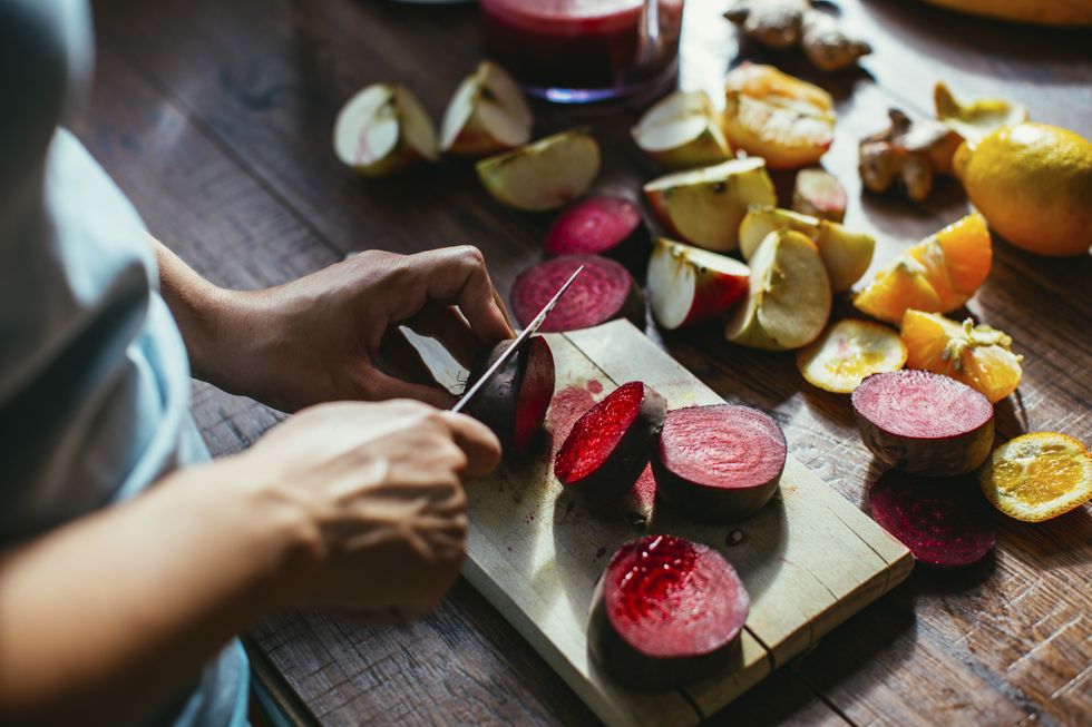 PERSON CUTTING BEETROOT