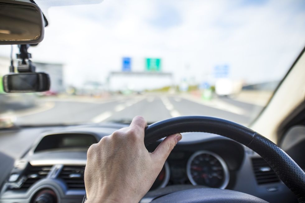 Person driving car on motorway road