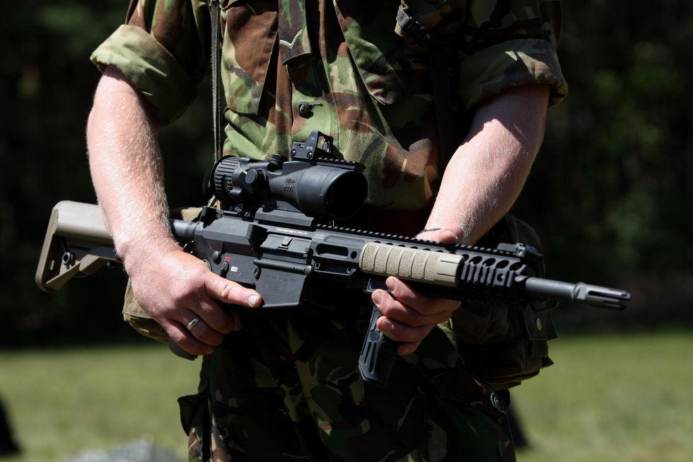 Person from Army holding a gun