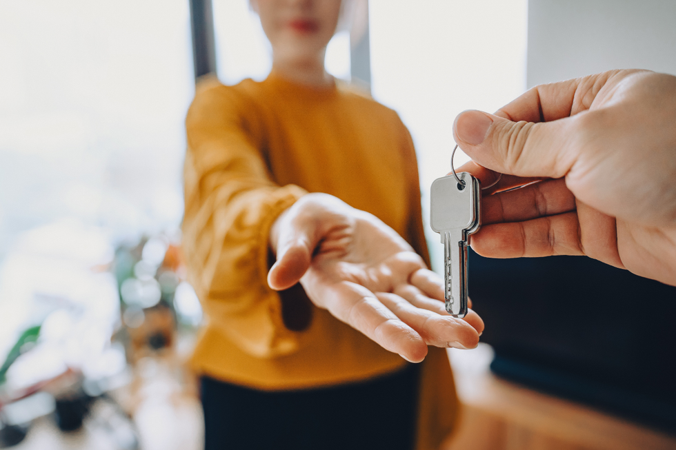 Person handing keys to buyers