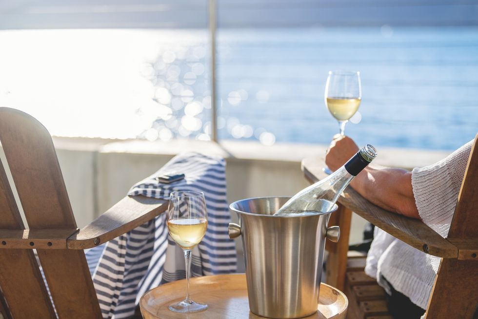Person holding a glass of wine on.a cruise ship