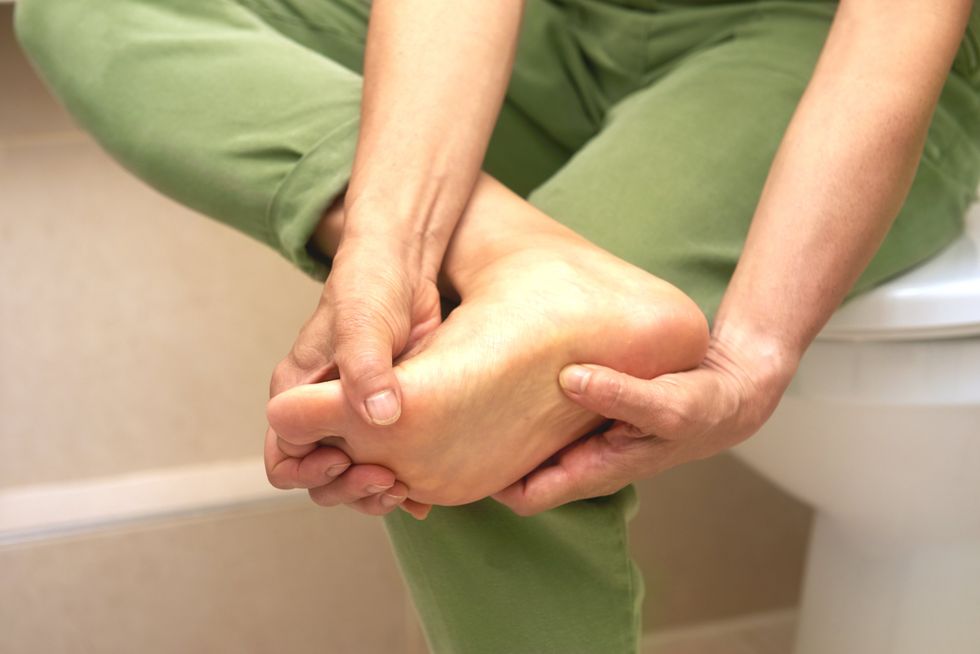 PERSON HOLDING THEIR FOOT
