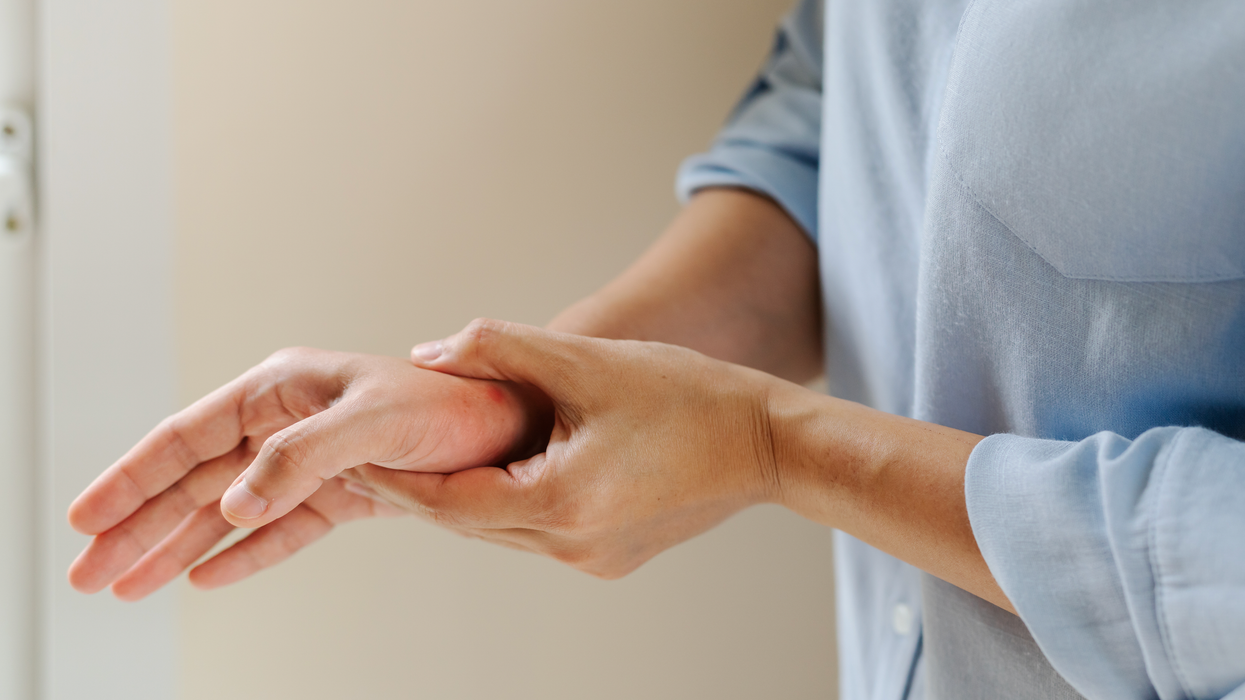 Person holding their hand
