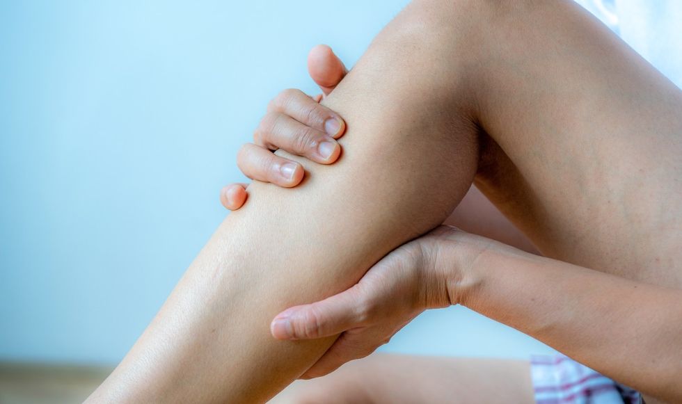 Person holding their leg